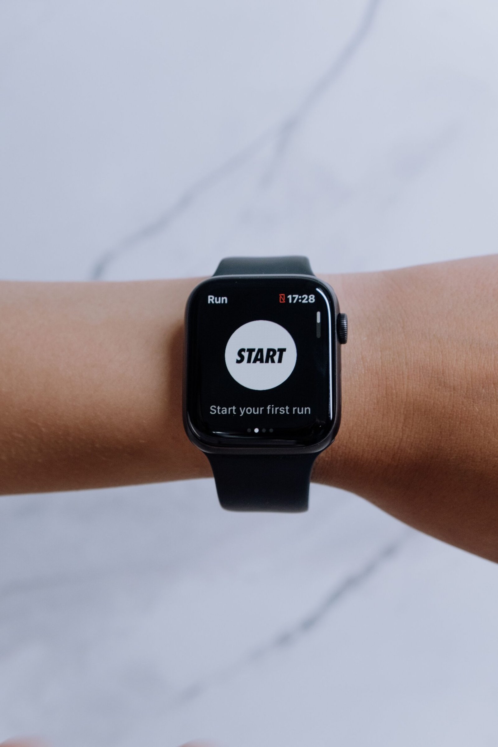 Runner checking their pace per kilometer on a GPS watch following pace calculator results