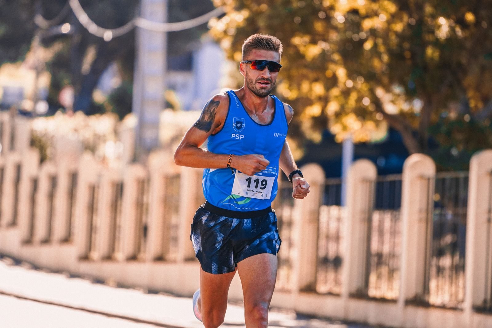 Focused runner in a city race following his 10K training plan