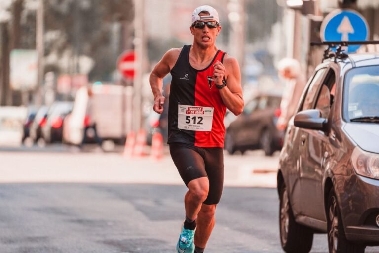 Runner in a cap and sunglasses during a 10K city race
