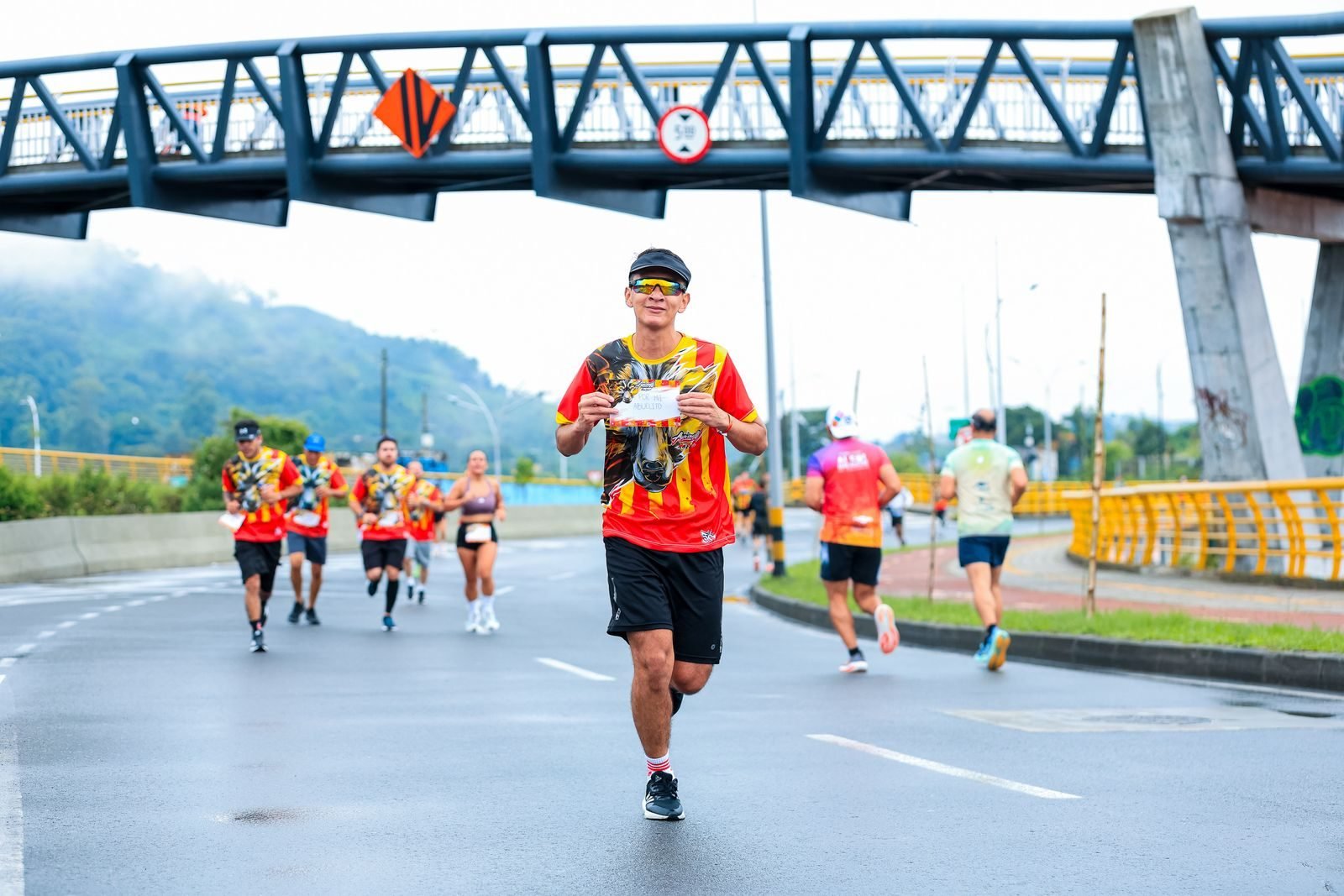 Runners in colourful shirts in a city race like the Cursa de Bombers