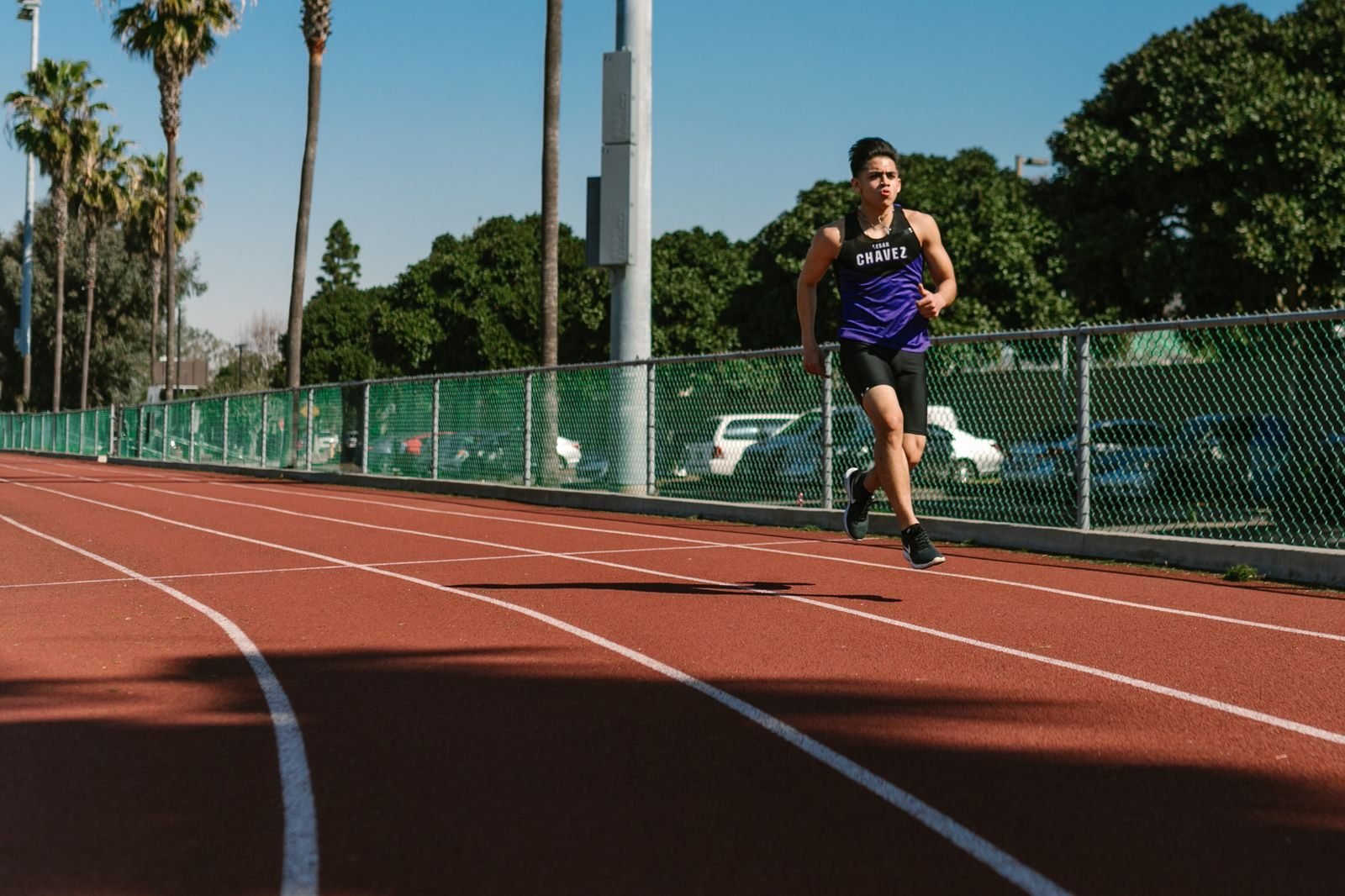 Runner doing intervals on an outdoor athletics track to train critical power