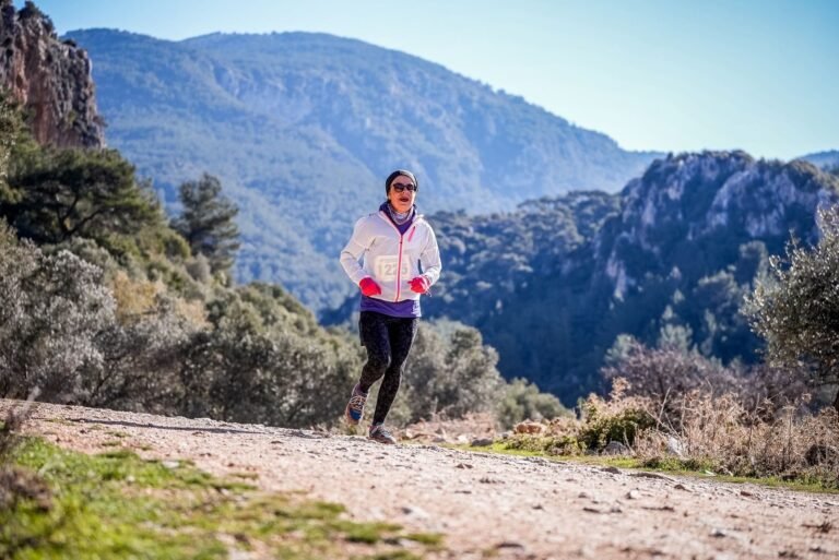 Female trail runner on a path with mountains behind, illustrative photo for Cursa de Muntanya de Girona 2026