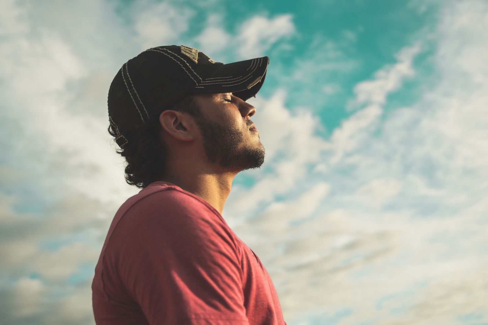 Man breathing deeply outdoors to ease a stitch