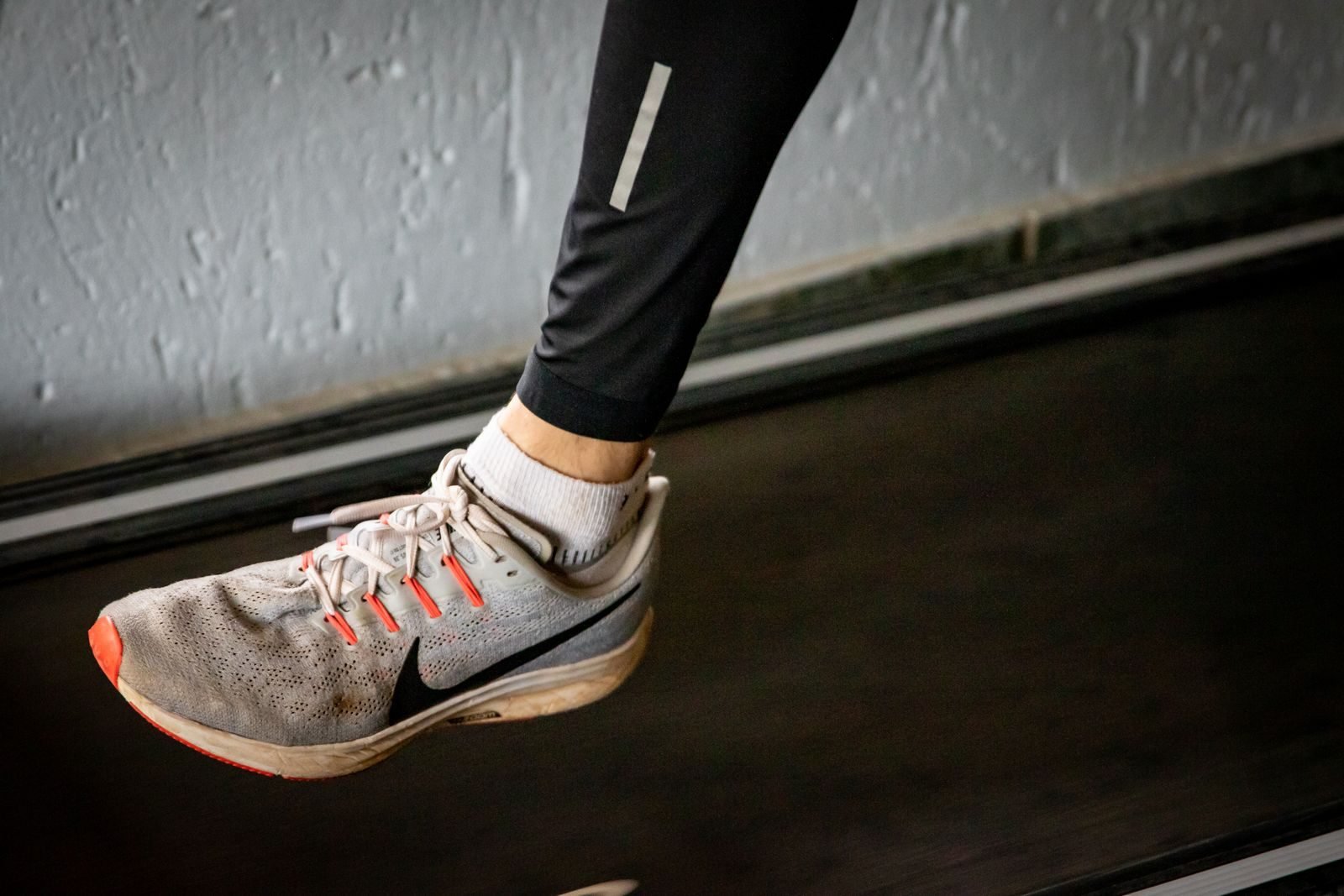 Running shoe on a treadmill showing the midsole cushioning