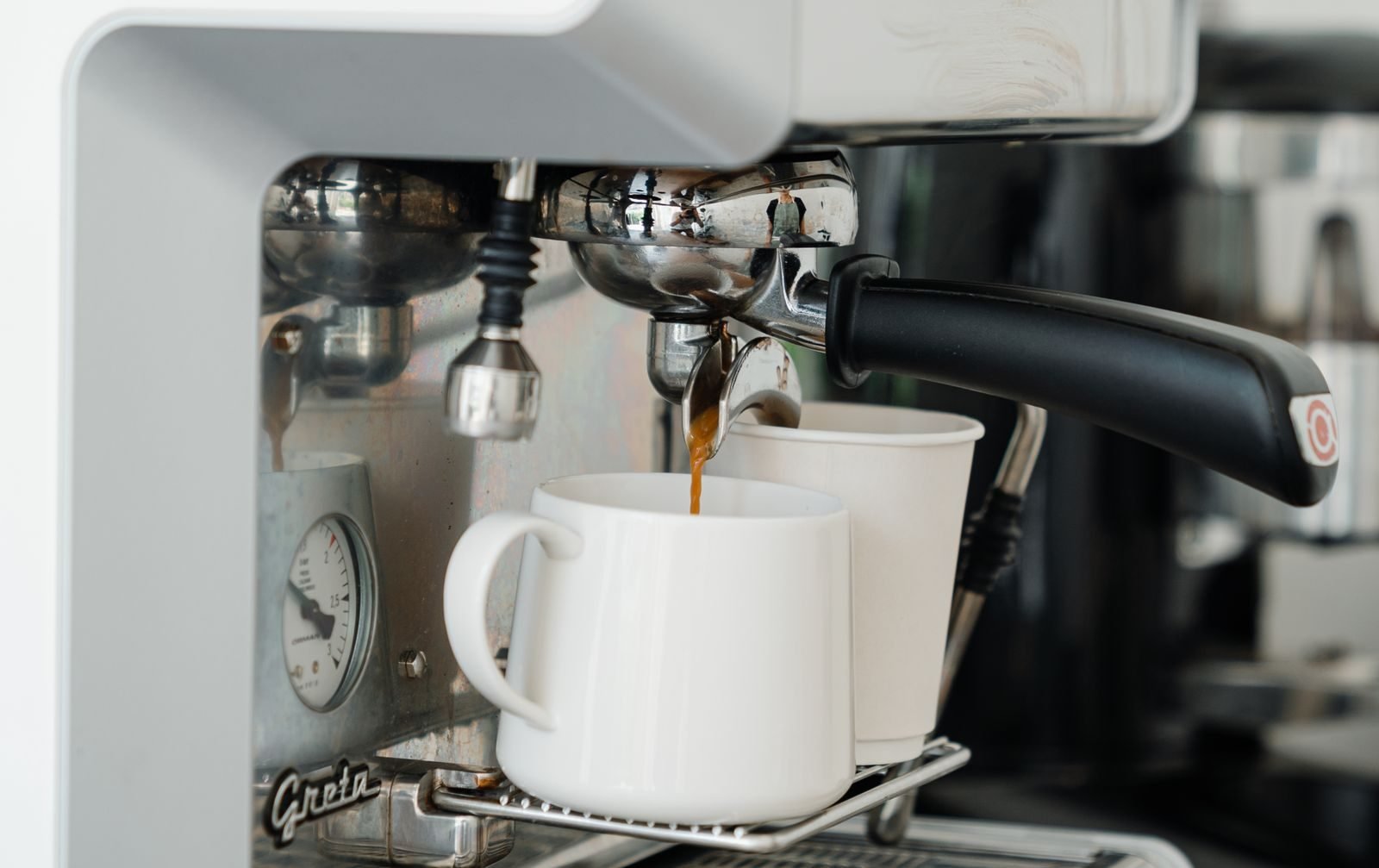 Coffee machine pouring fresh coffee into a cup