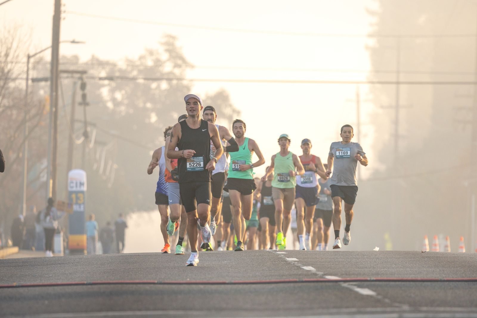 Runners in a road race on a foggy morning
