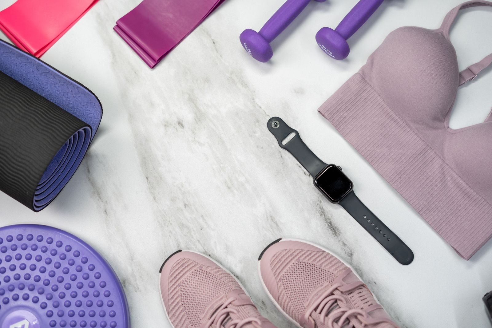 Fitness gear with a smartwatch on a marble surface