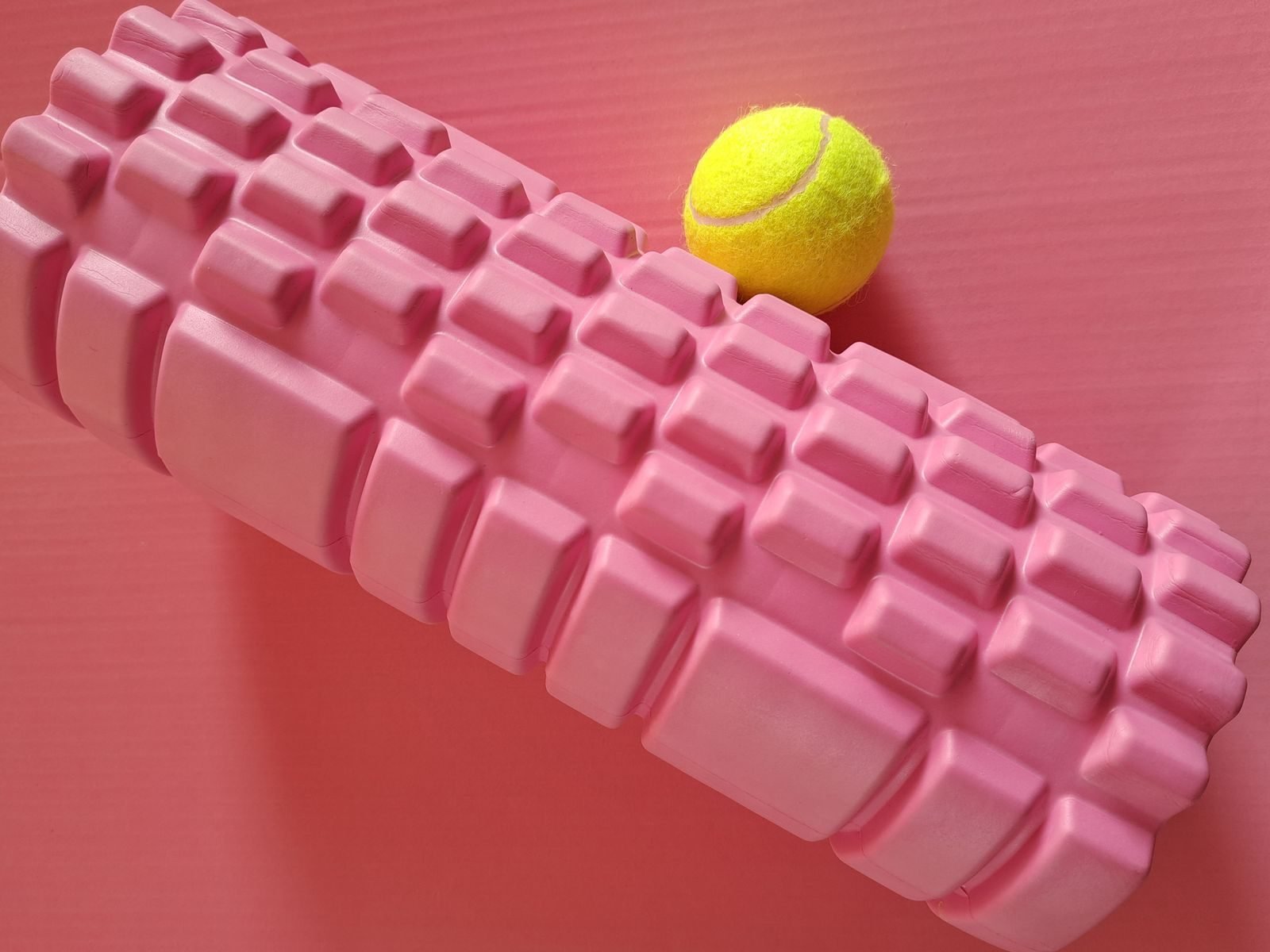 Foam roller and tennis ball for massaging the sole of the foot