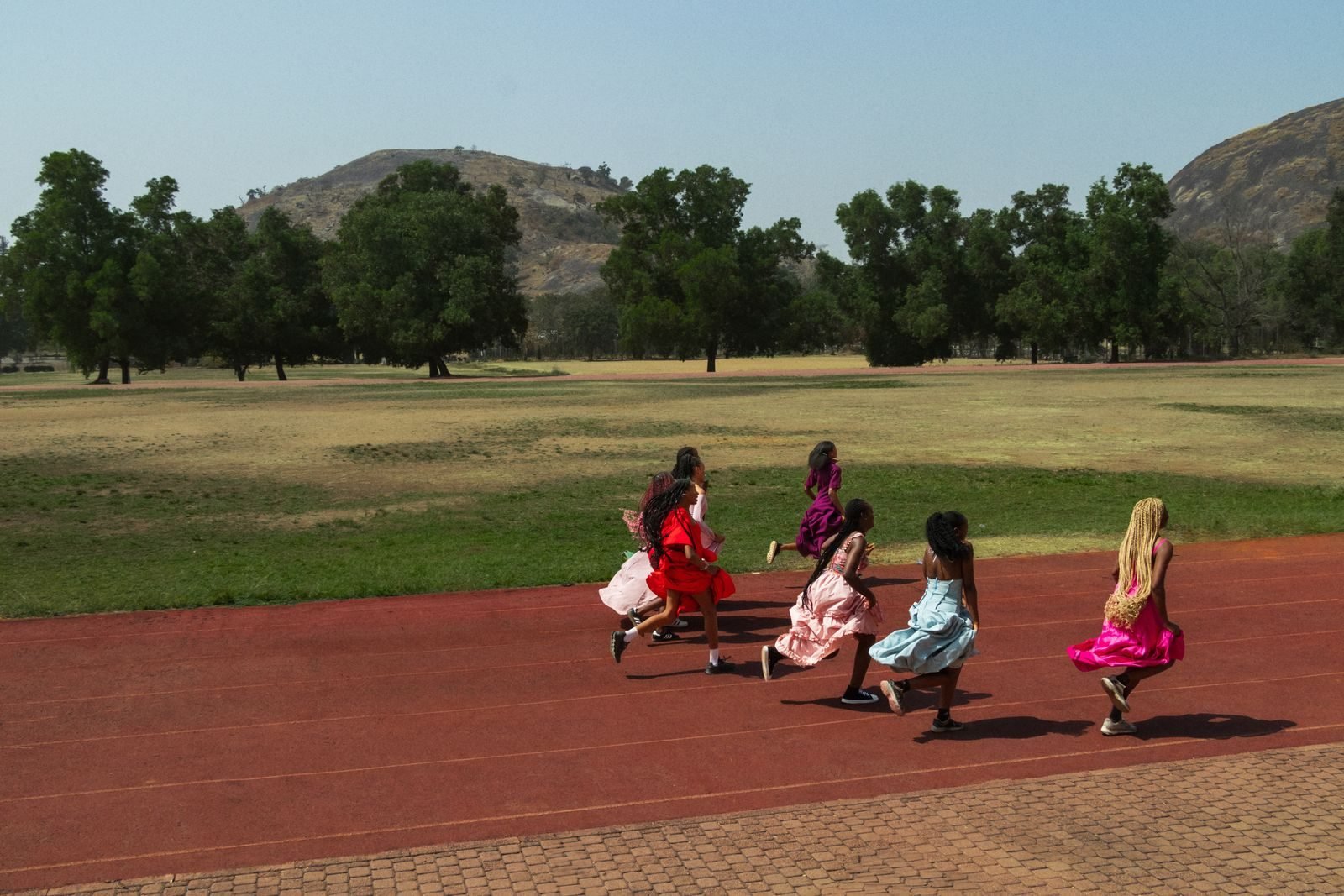 Girls running on an outdoor athletics track