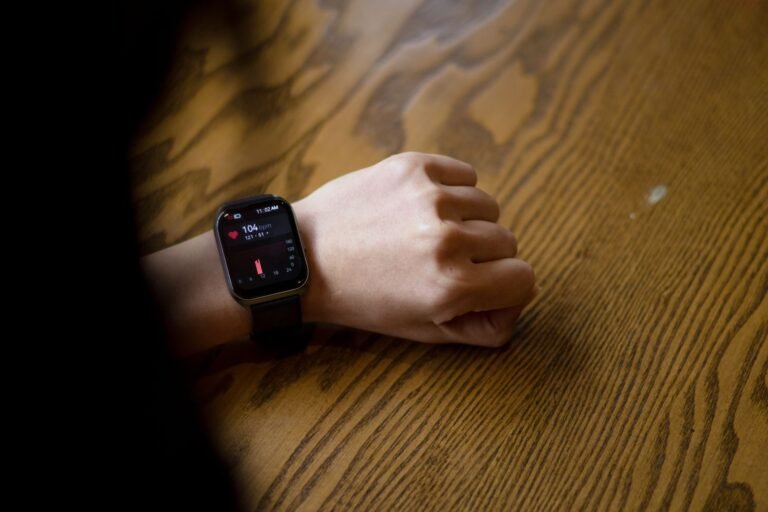 Smartwatch showing 104 beats per minute on a wrist