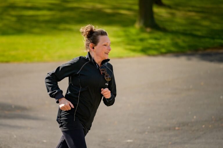Woman running through a park on a sunny day