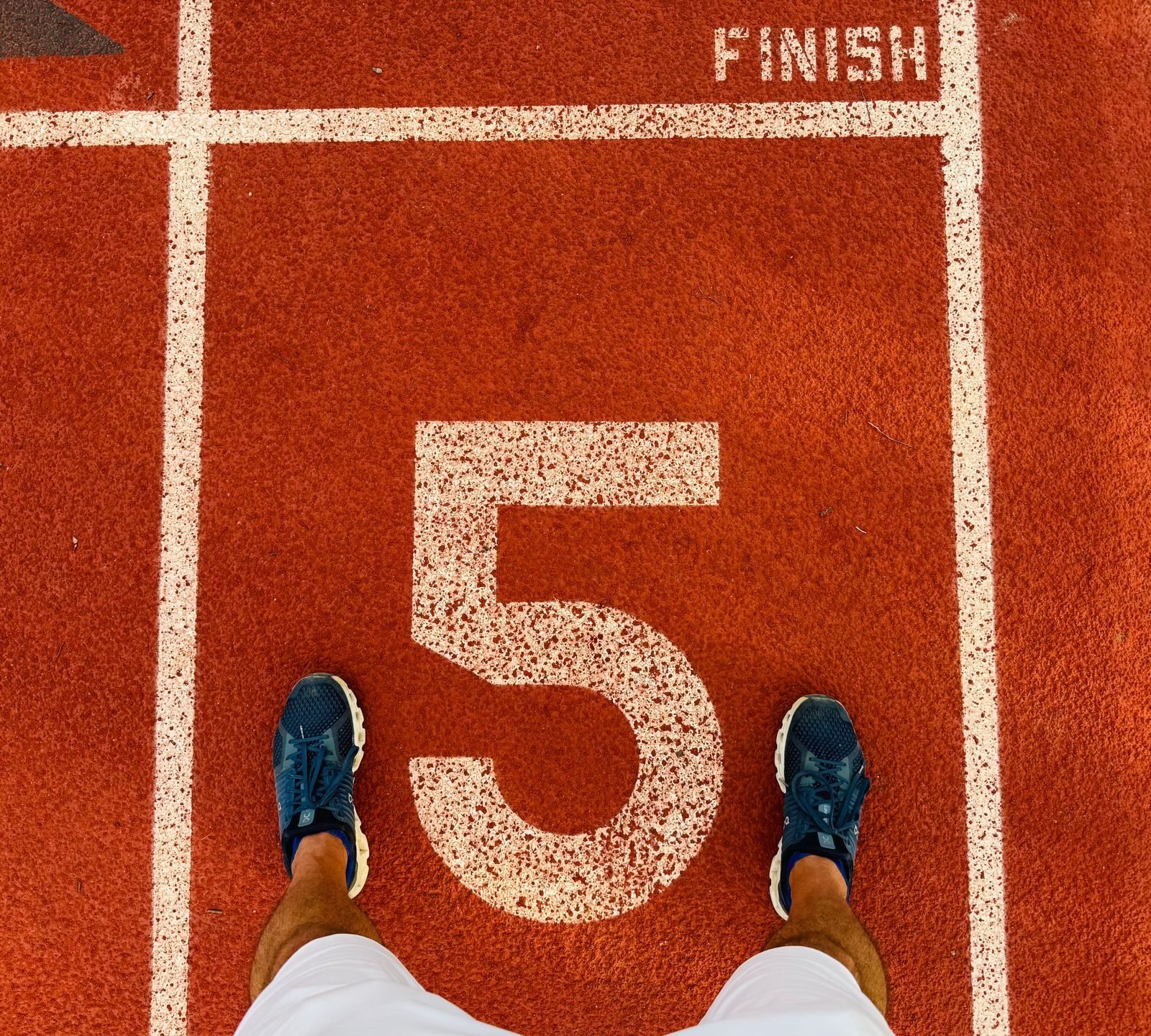 Runner feet in lane 5 of an athletics track