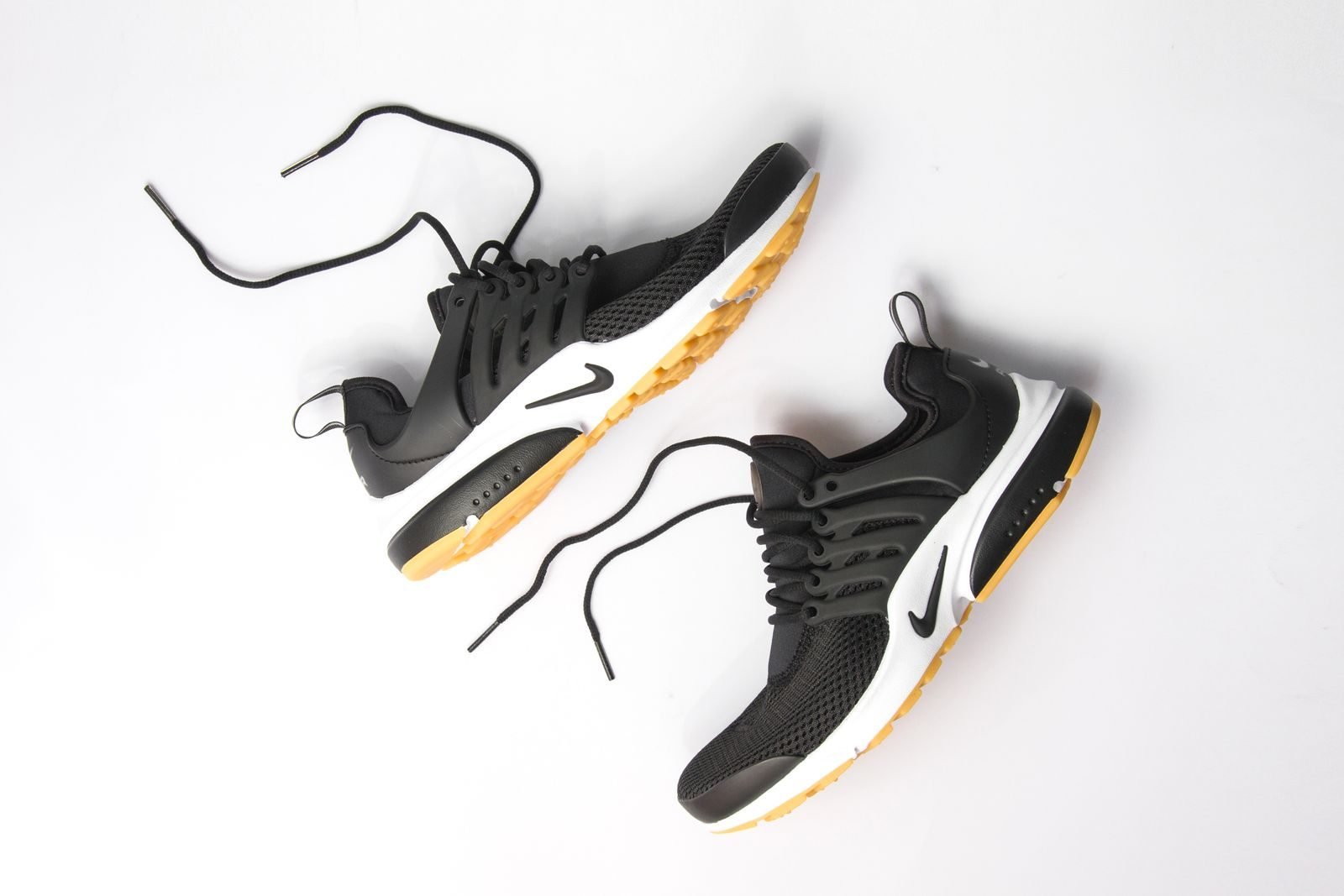 Black sports shoes with breathable mesh seen from above
