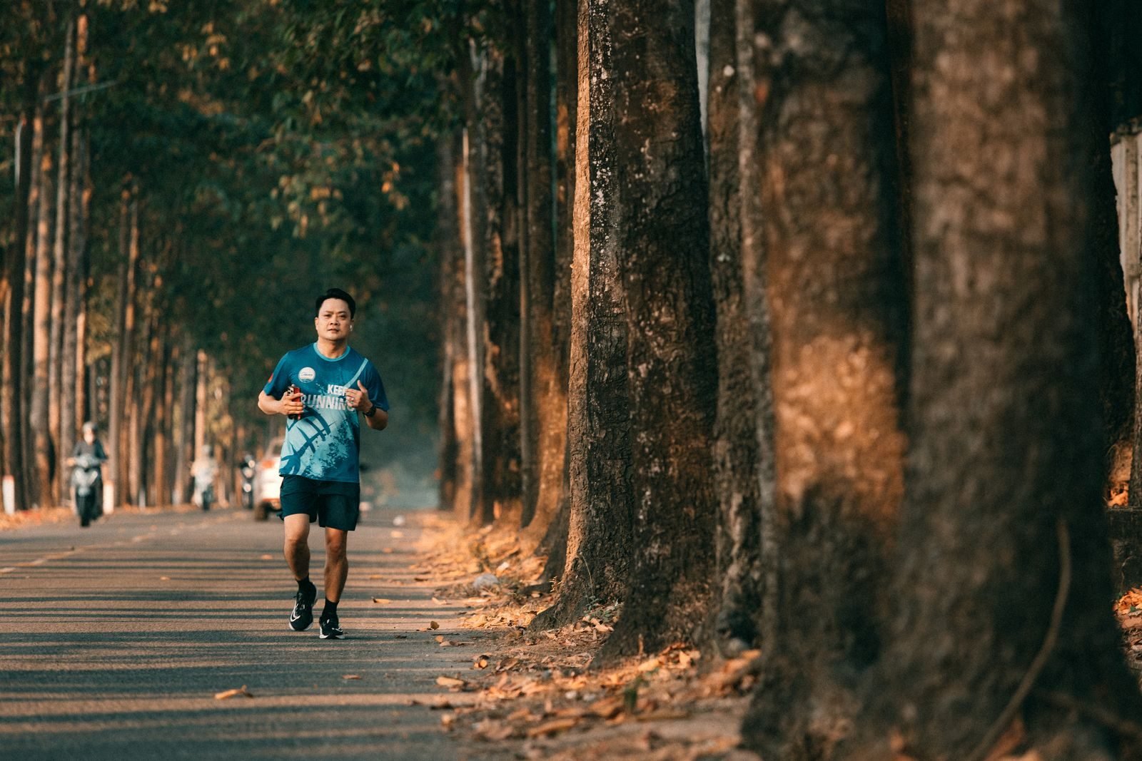 Runner doing a long run for his first half marathon on a tree-lined road