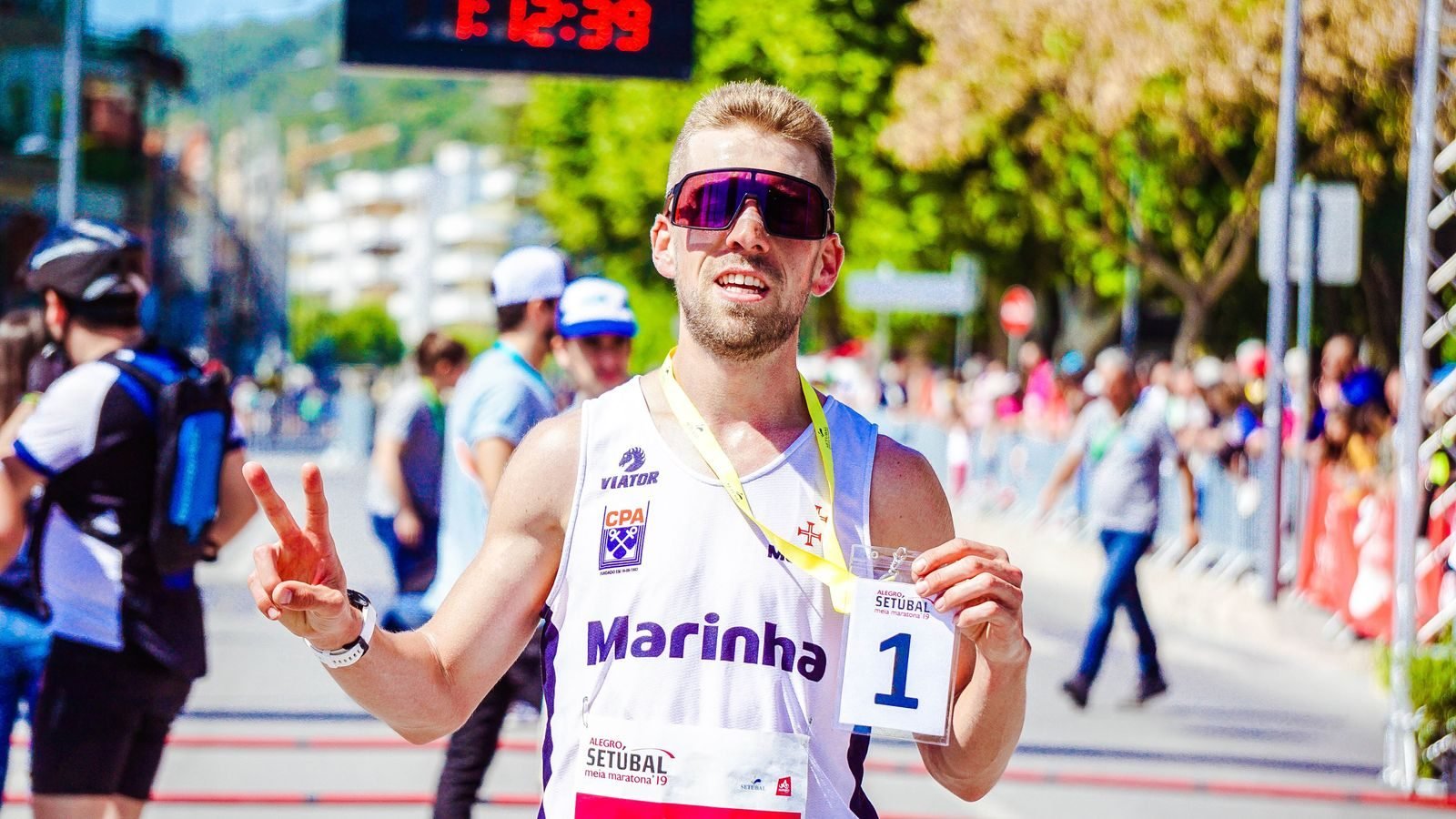 Athlete celebrating at the finish of an outdoor marathon after a sub-4 marathon