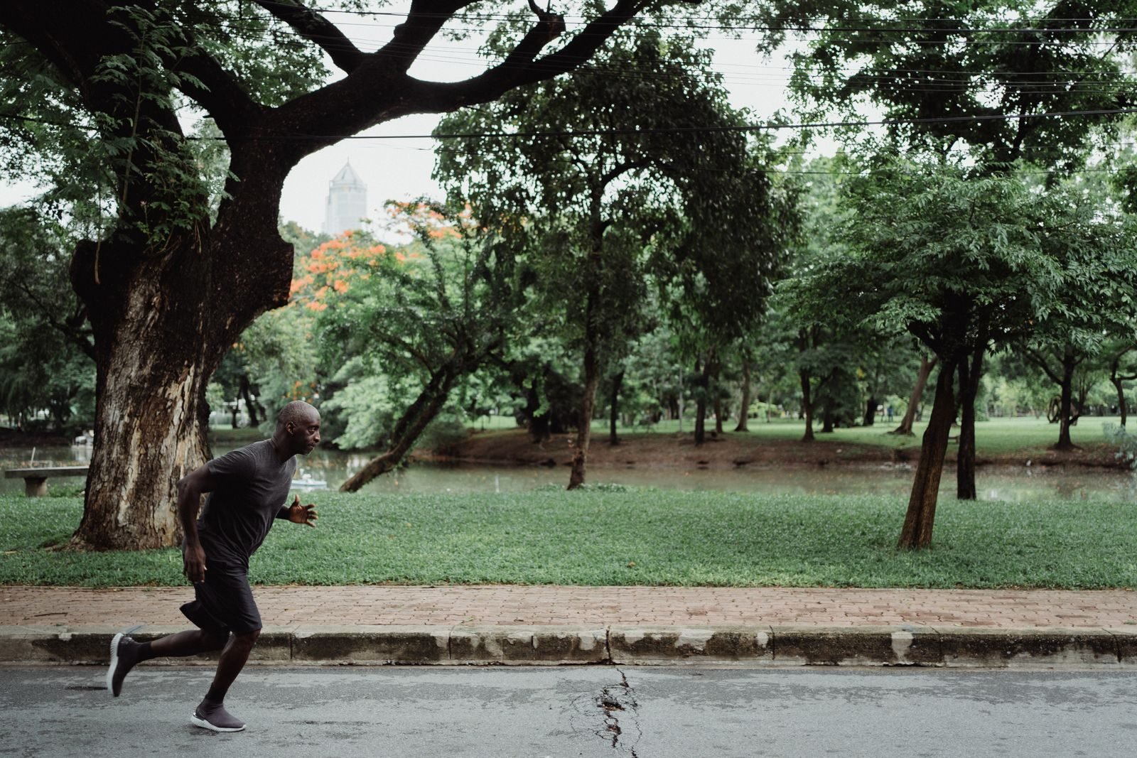 Man running in a green park