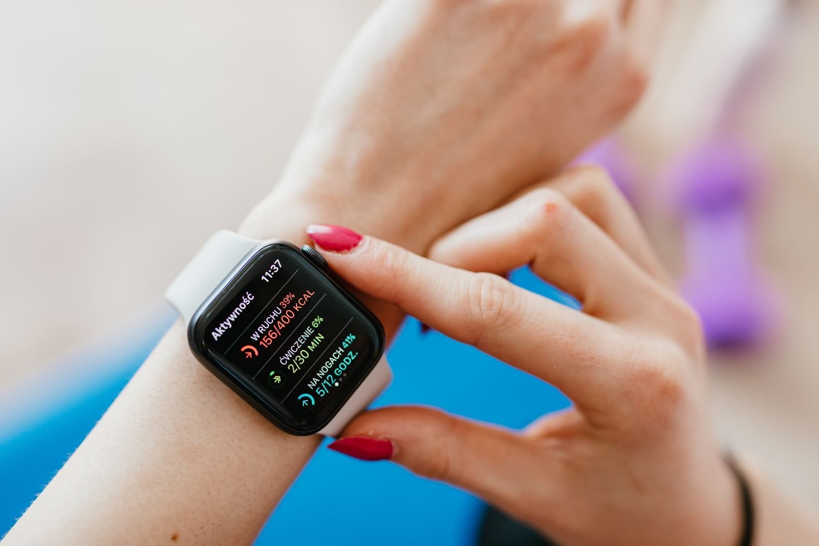 Woman sitting on a mat checking her resting heart rate on her watch