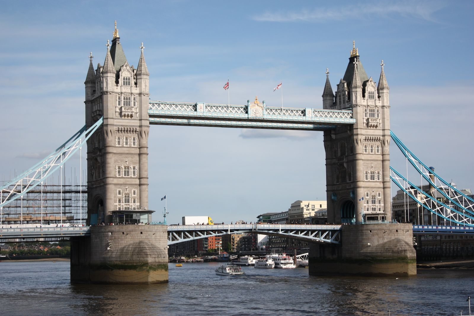 Boats on the Thames by Tower Bridge on a clear day