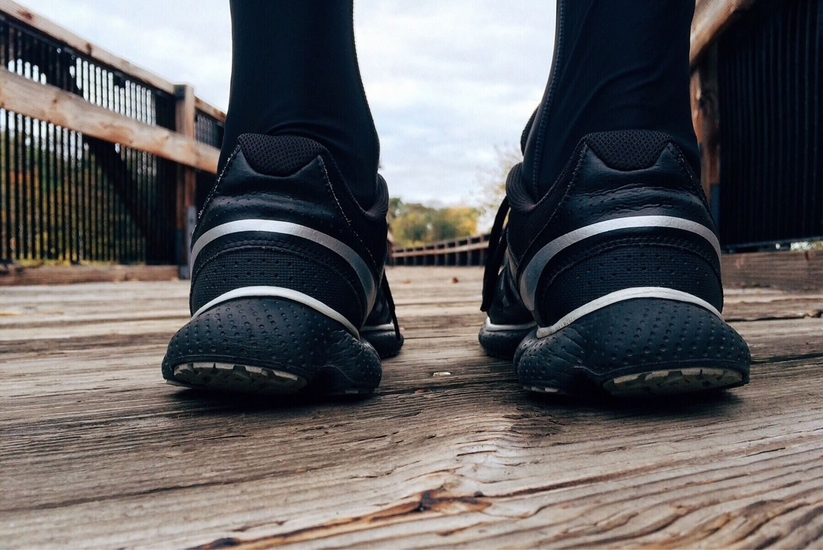 Running shoes on a wooden bridge during a run