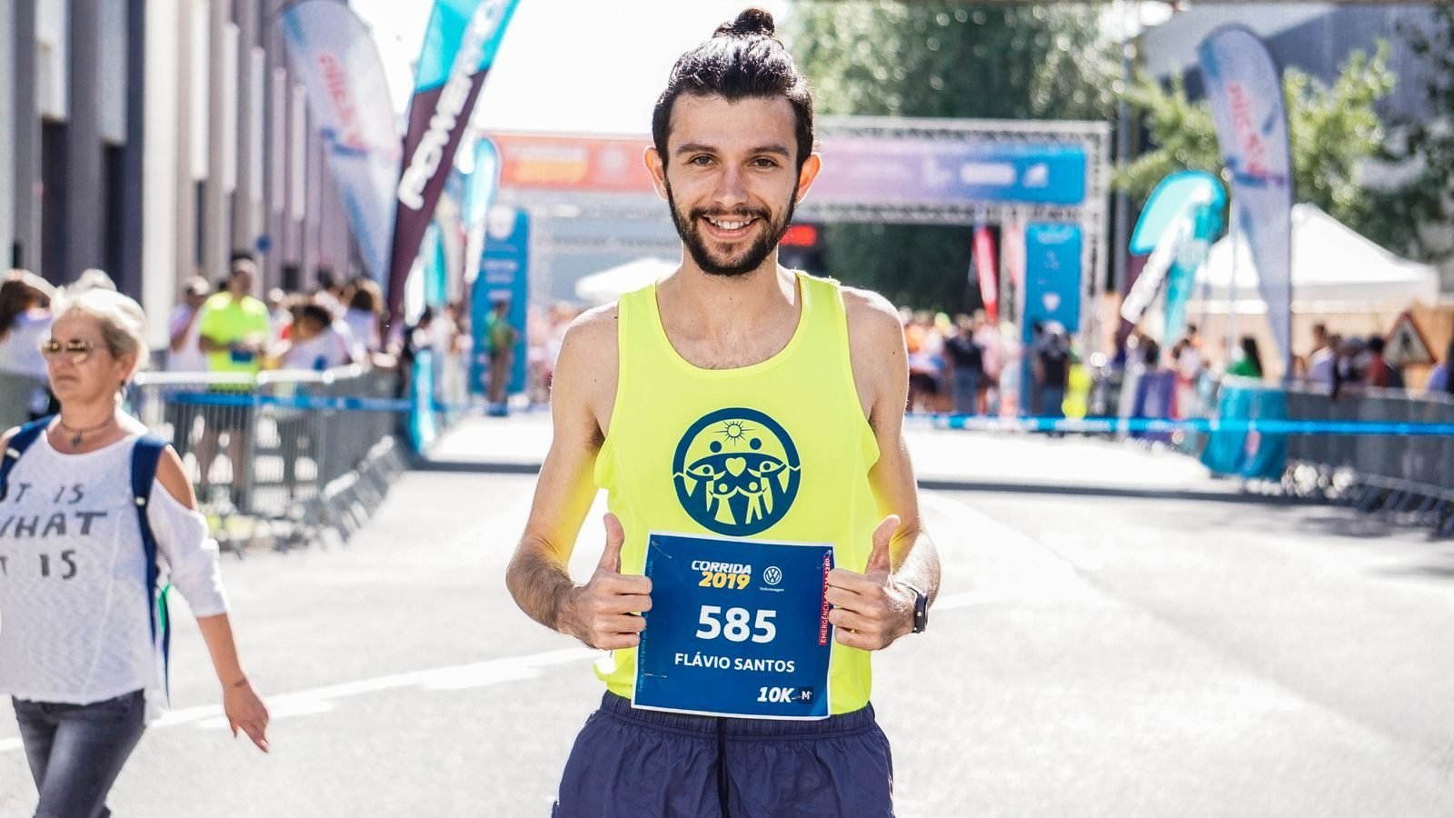 Smiling runner giving a thumbs up after finishing a marathon