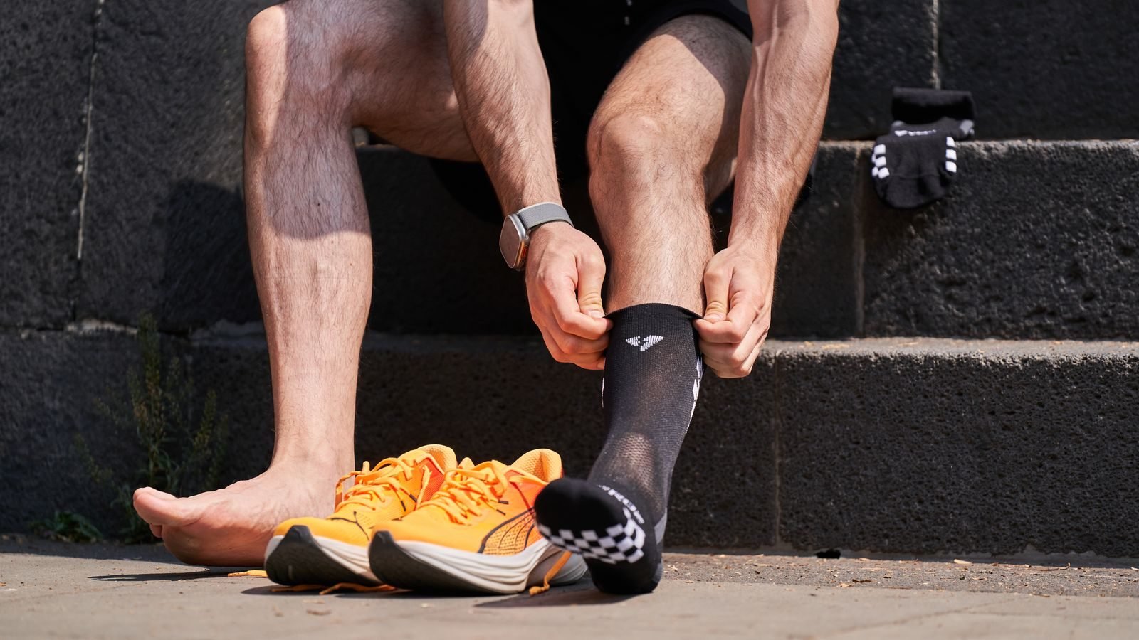 Runner putting on his socks before a run