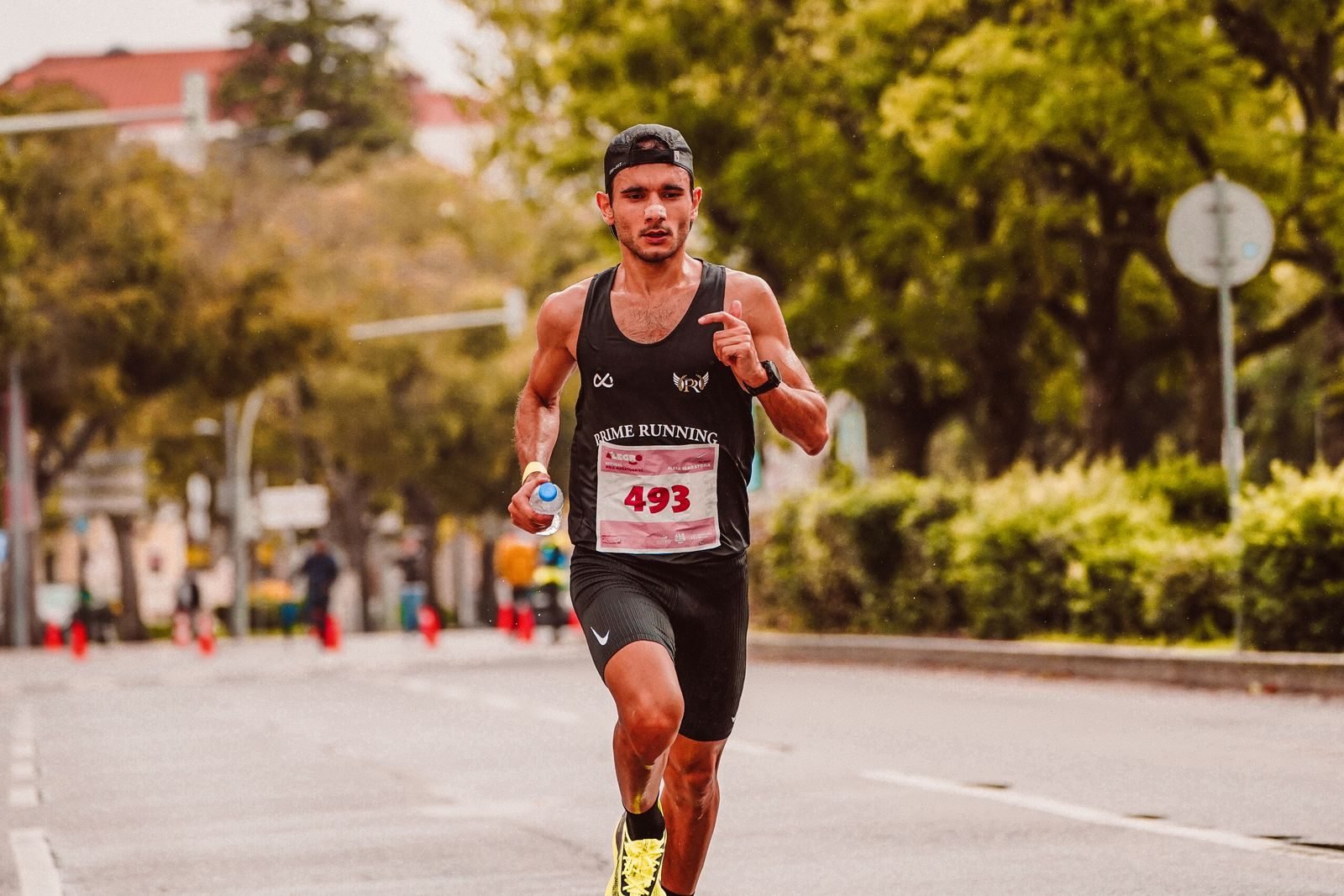 Runner holding a water bottle during a race