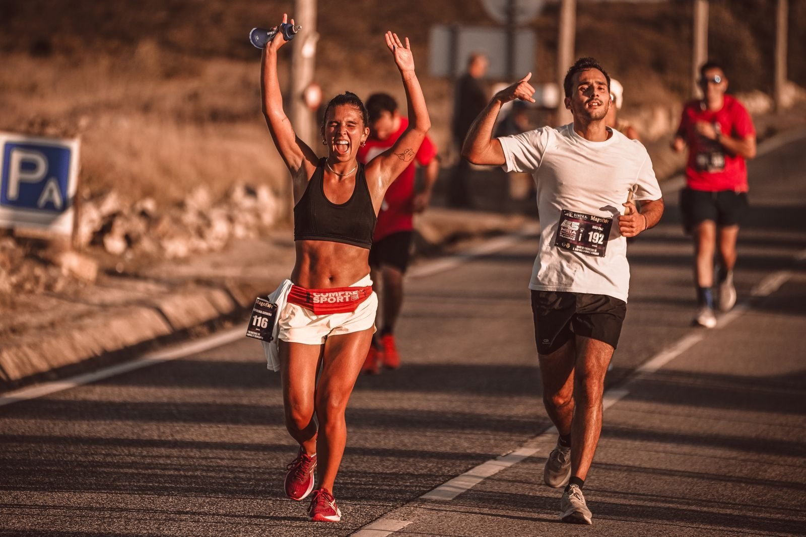 Runners celebrating during a sunny road race