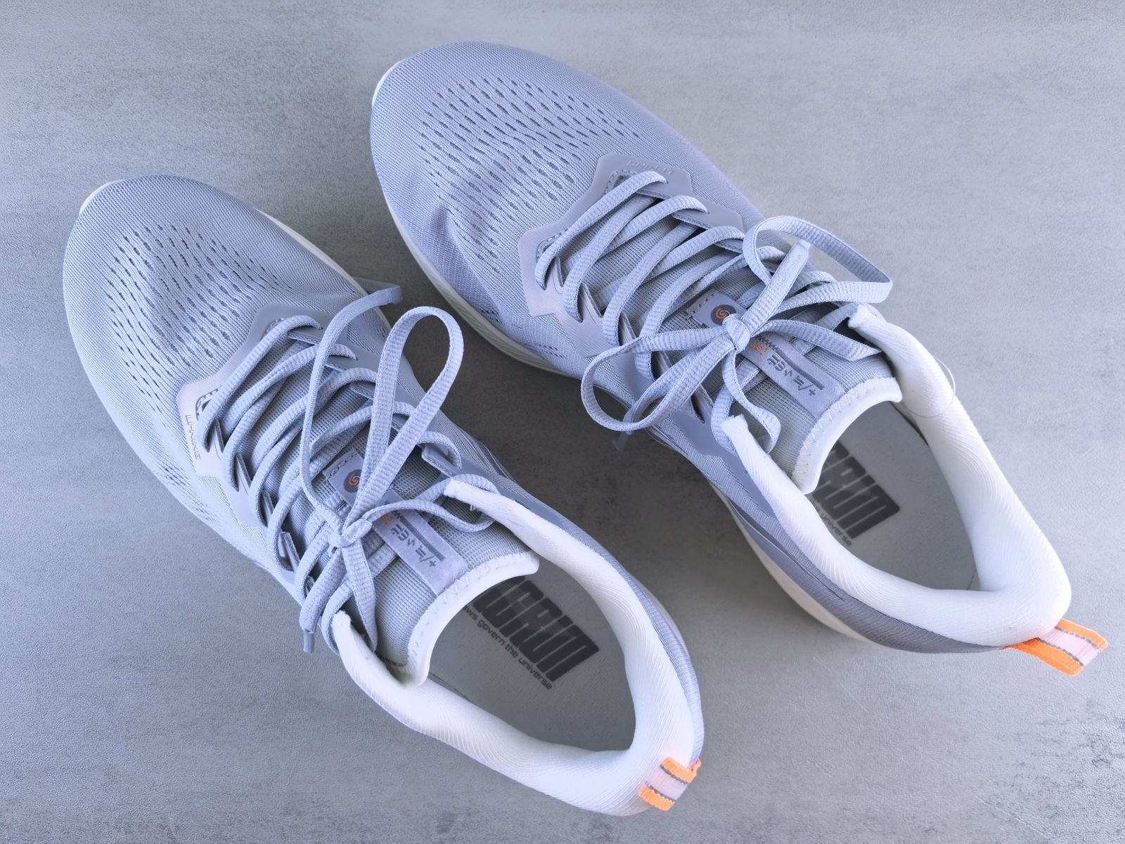Grey sneakers seen from above on a grey background