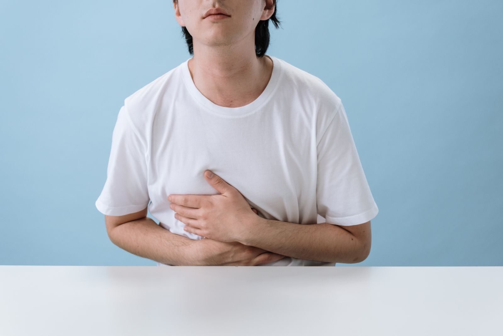 Man holding his side with a side stitch