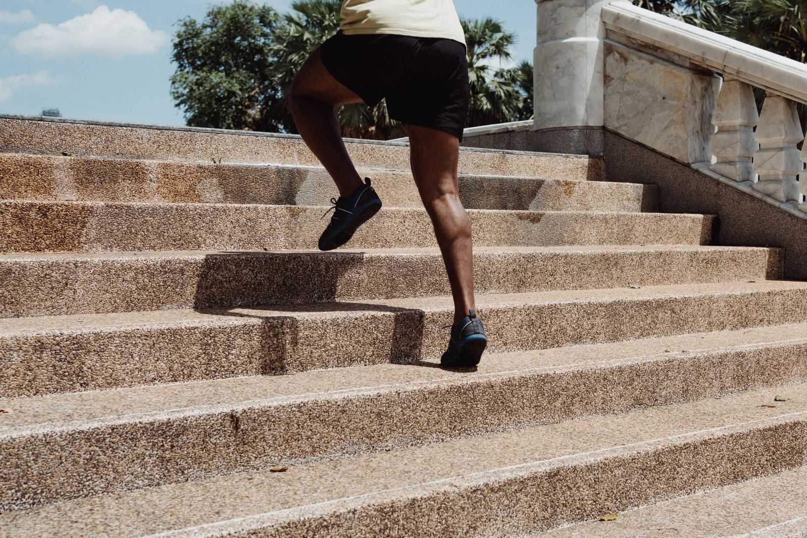 Runner sprinting up concrete stairs