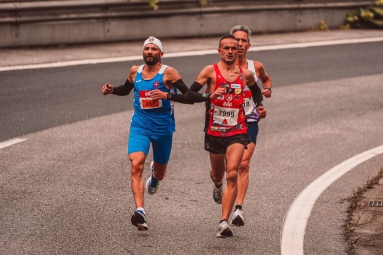 Three runners racing on a city road