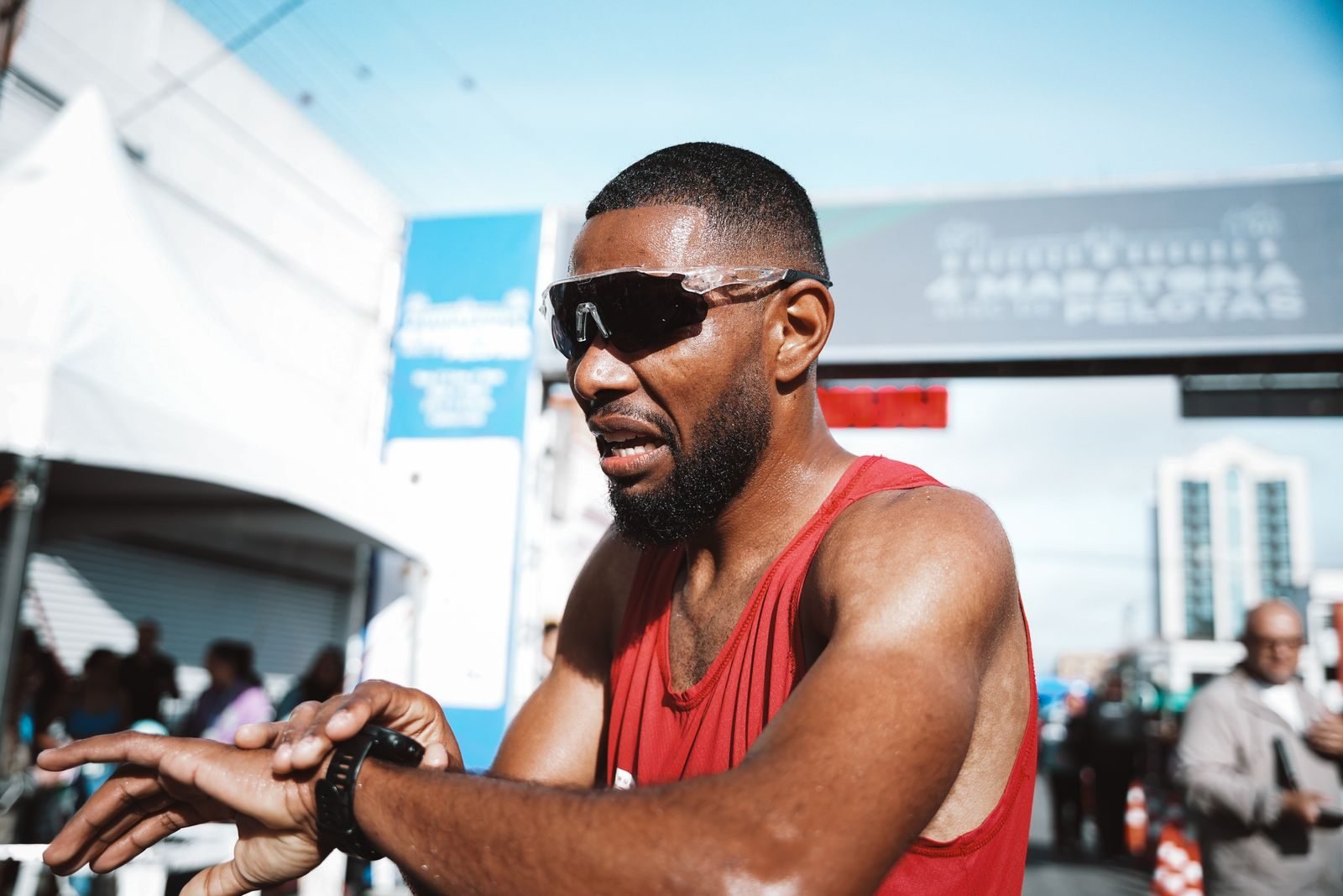 Runner checking his time on his watch at the finish line