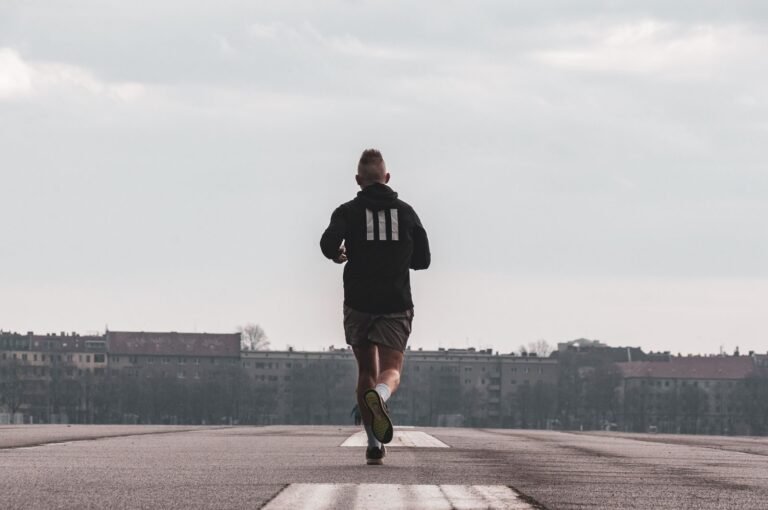 Runner doing a tempo run at dawn on an urban runway