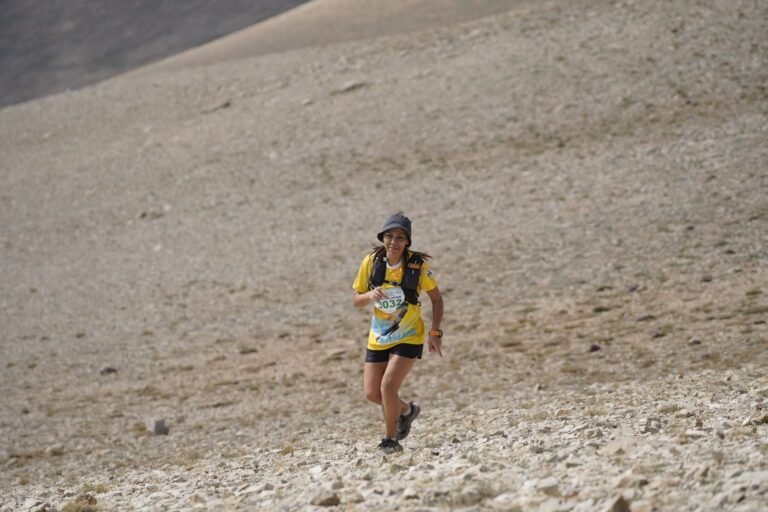 Trail runner climbing a stony slope, illustrative photo for Trail Les Ermites 2026