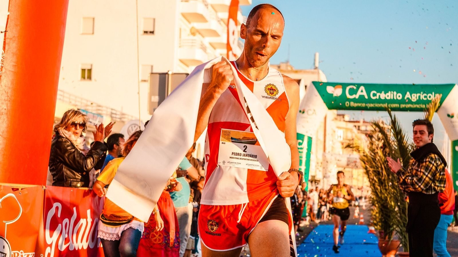 Runner crossing a marathon finish line in triumph