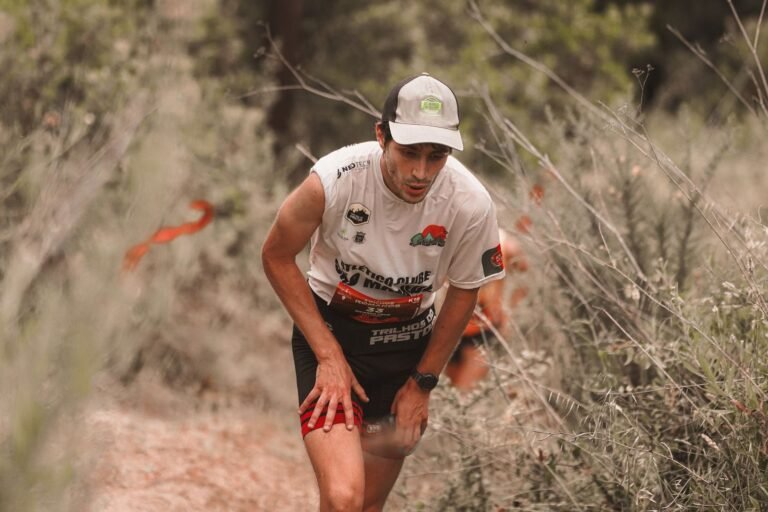 Trail runner with a bib leaning into a climb, illustrative photo for Ultra Penedès 2026
