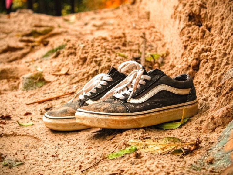 Worn-out sneakers on sand, a sign of when to replace running shoes