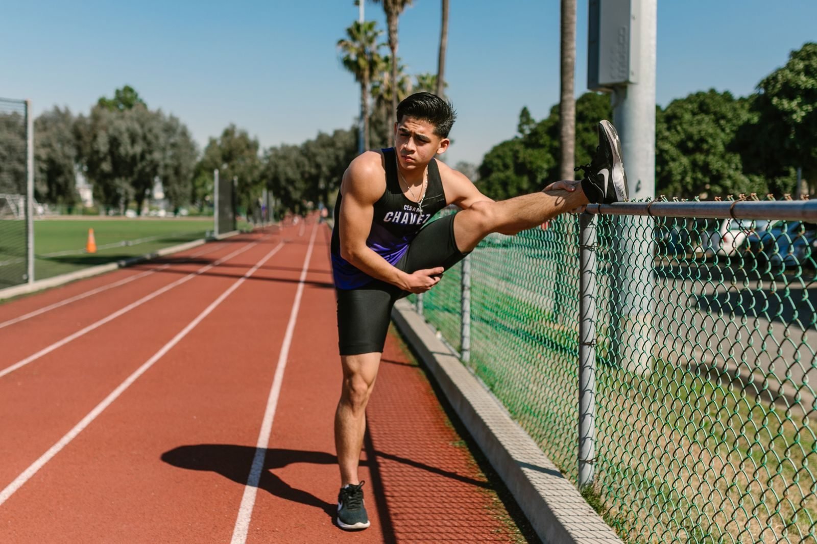 Athlete stretching on the track before training, the zone 1 warm-up